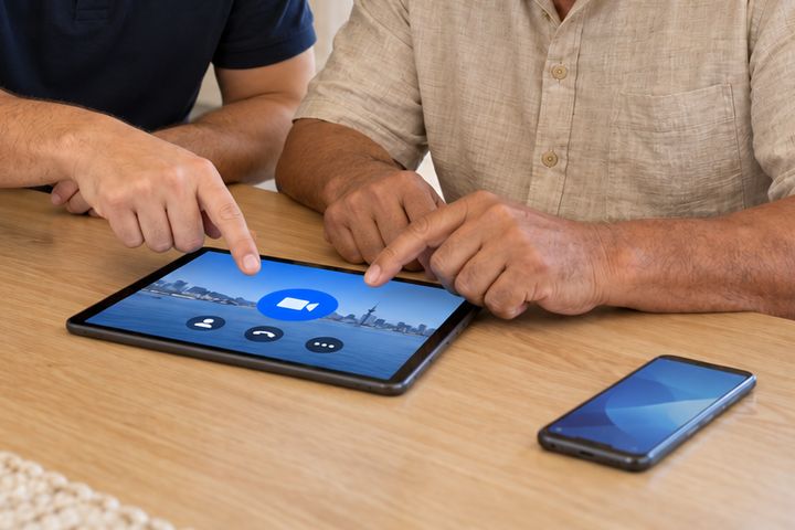 Two people starting a video call on a tablet